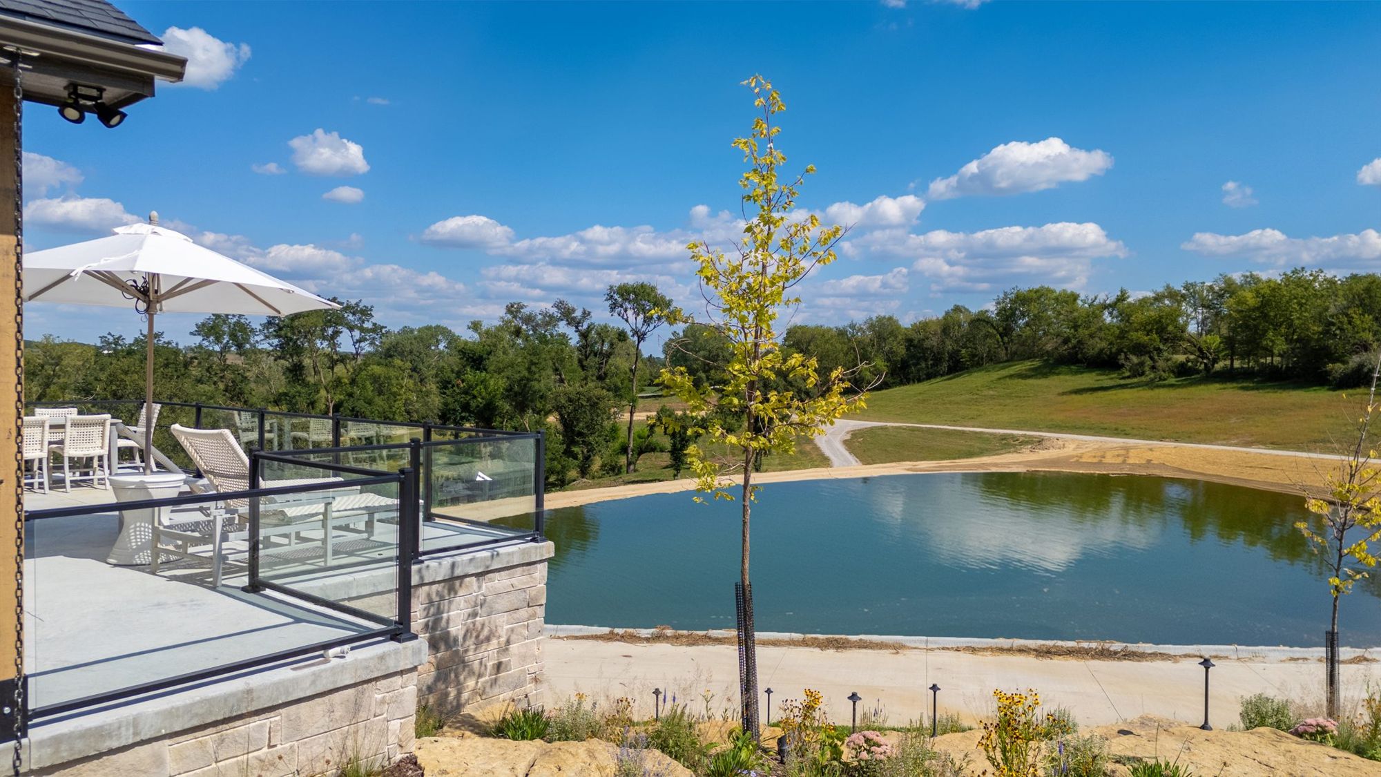 Pond with a sand beach beside the patio