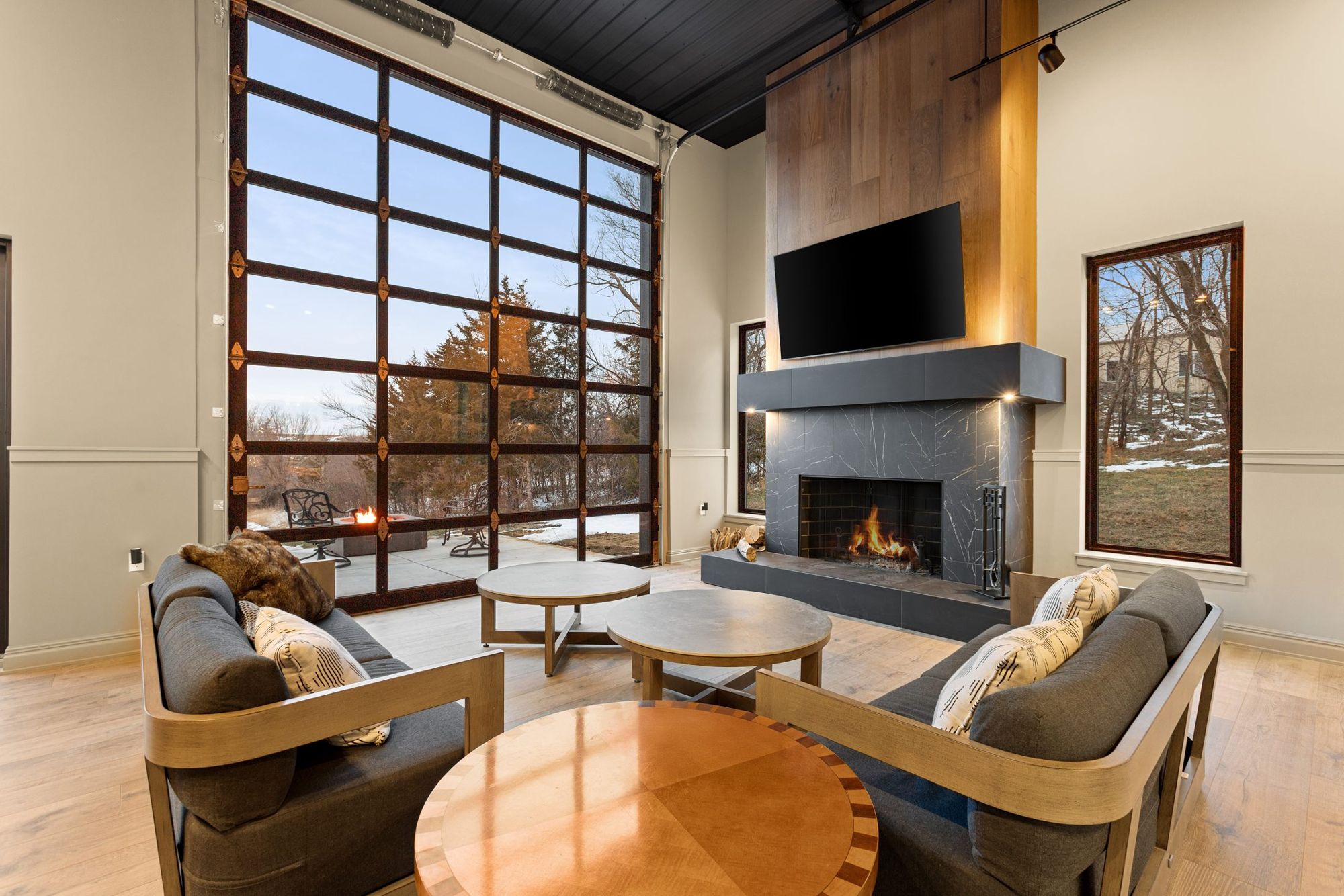 Barn lounge with a fireplace and a glass garage door