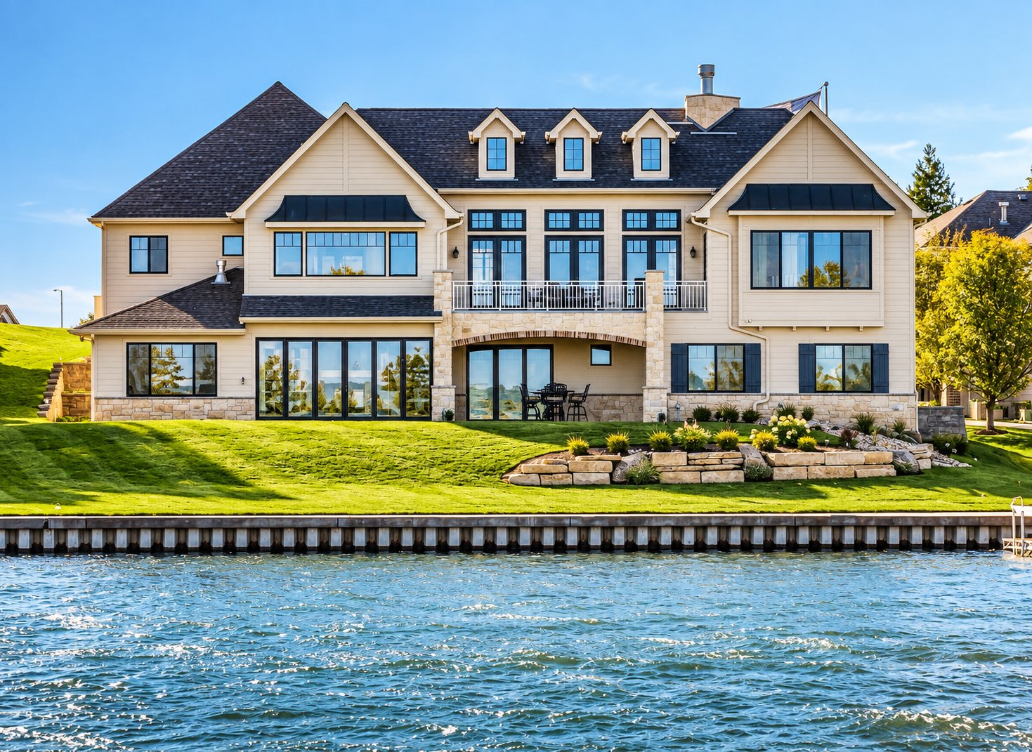 Lakefront home seen from the water with terraces down to the shore