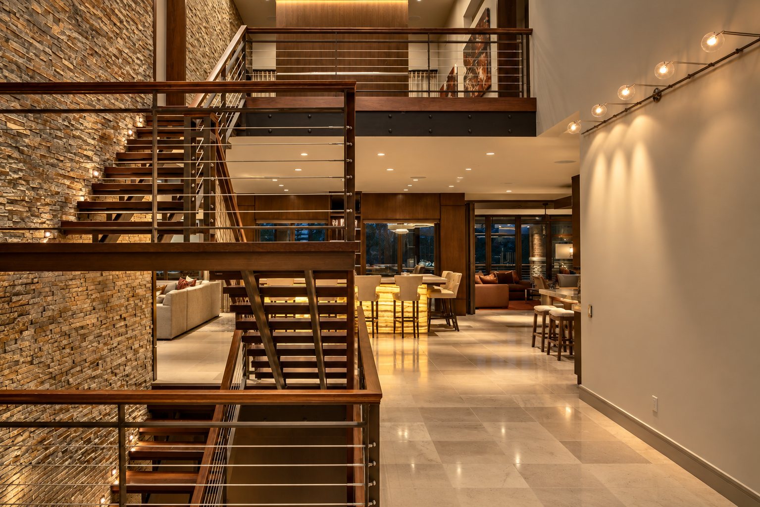 Open stair with wood treads beside a stacked-stone wall