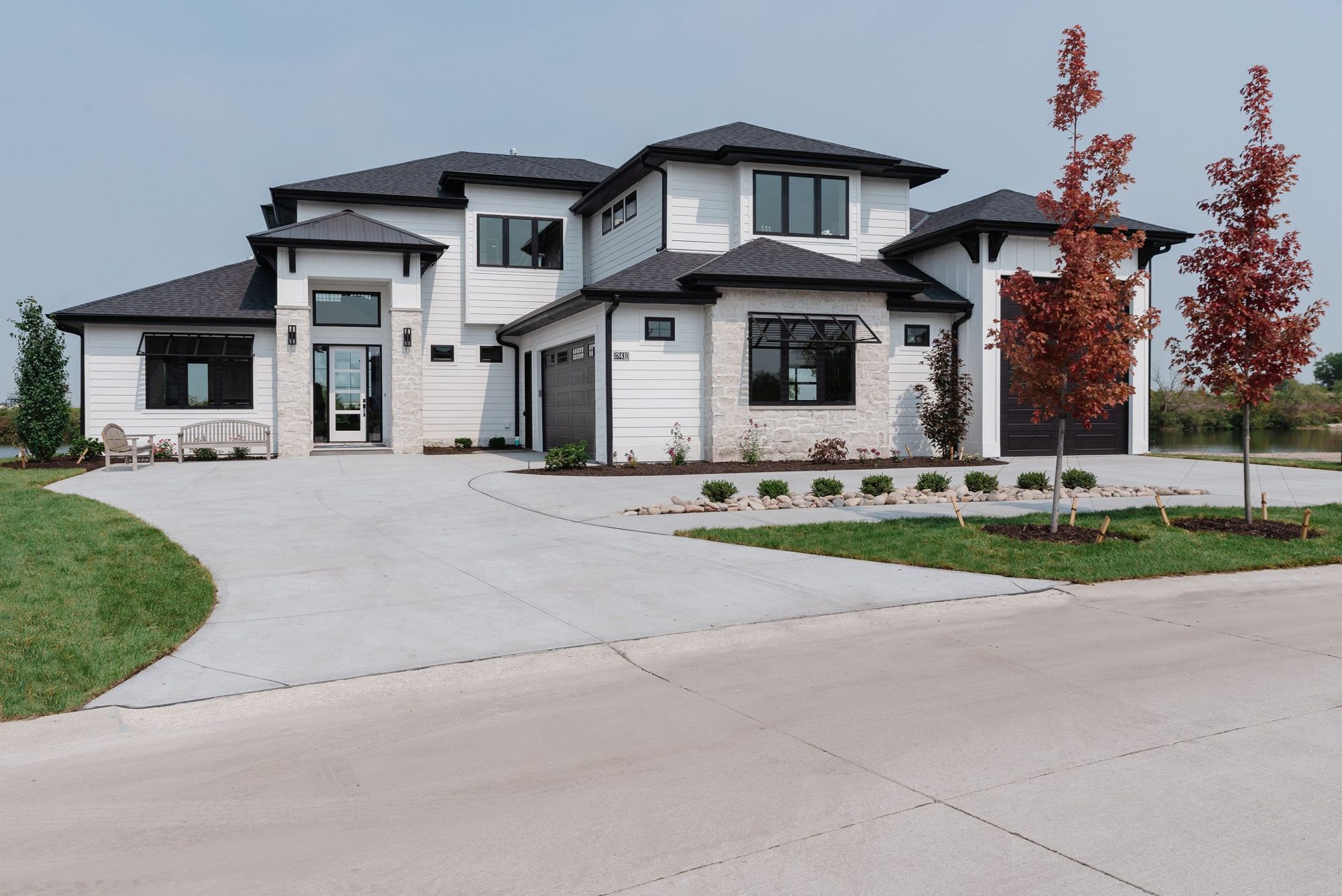 The 2021 Street of Dreams home at Flatwater Lake: white contemporary exterior with black trim