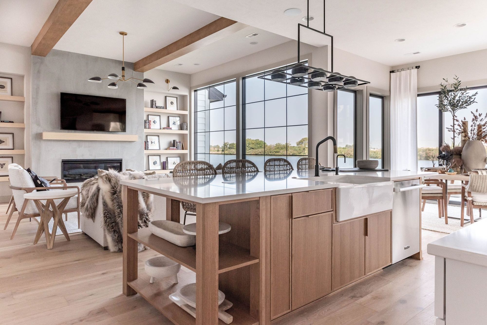 White-oak kitchen island with farmhouse sink and windows to the lake